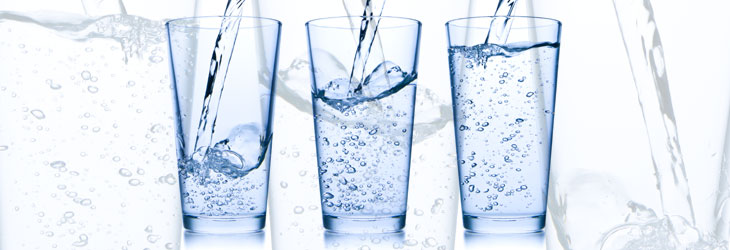 Water pouring into glasses